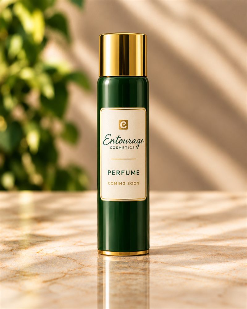 Concept image of an Entourage Cosmetics Perfume aerosol can in deep green with a gold cap and an ivory label marked Coming Soon.